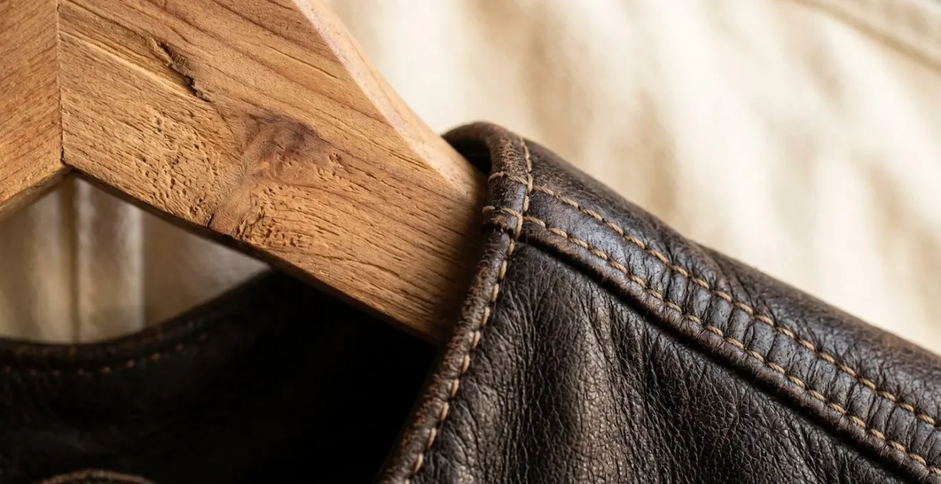 Leather jacket properly stored on cedar hanger in breathable cotton bag