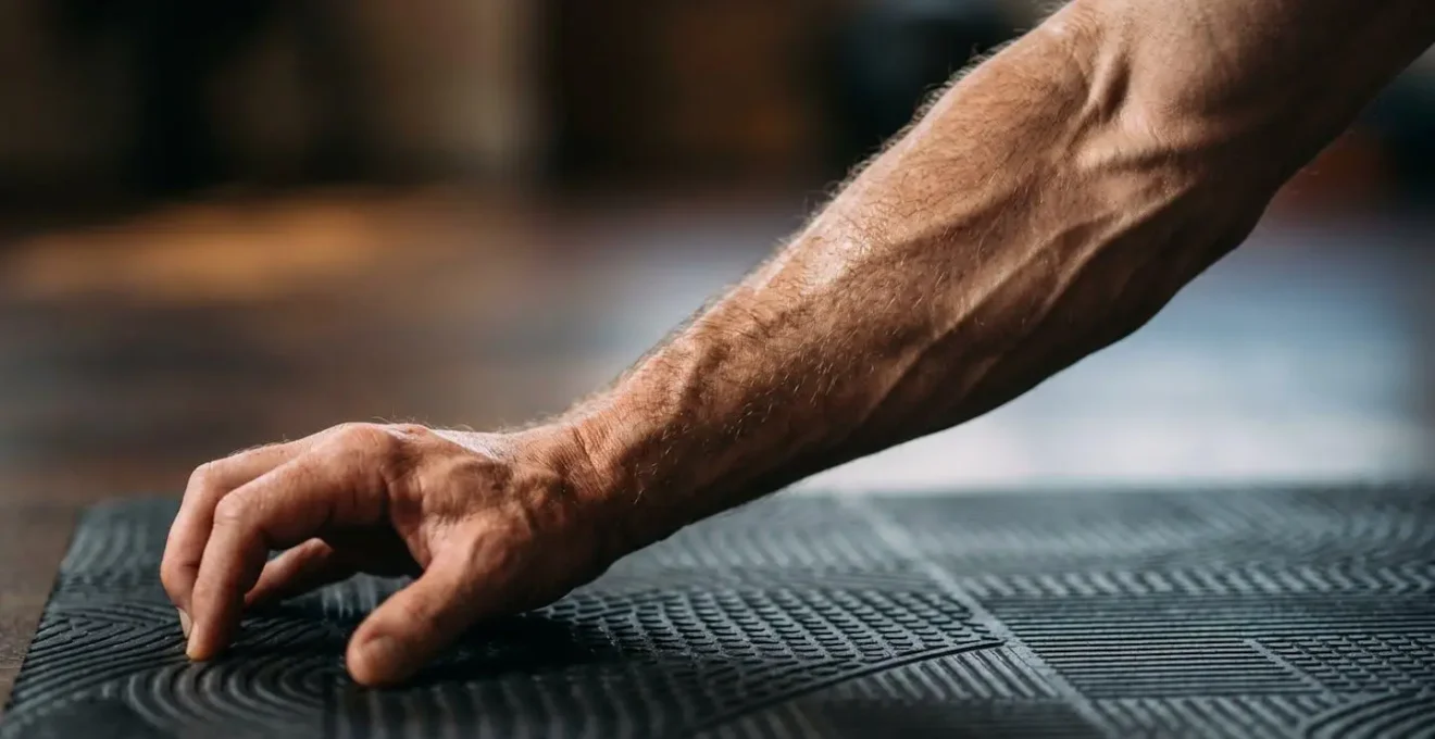 Middle-aged man demonstrating controlled movement combining yoga and Pilates elements
