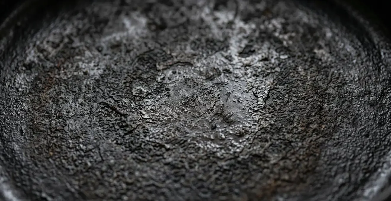 Vintage cast iron cookware displaying natural seasoning patina developed over decades of use